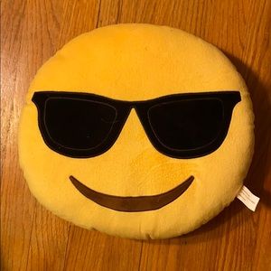 a yellow cool emoji pillow